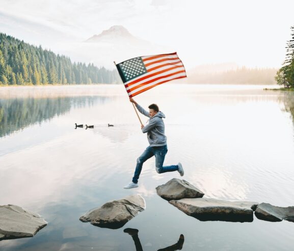 Fourth of July - man carrying the American flag